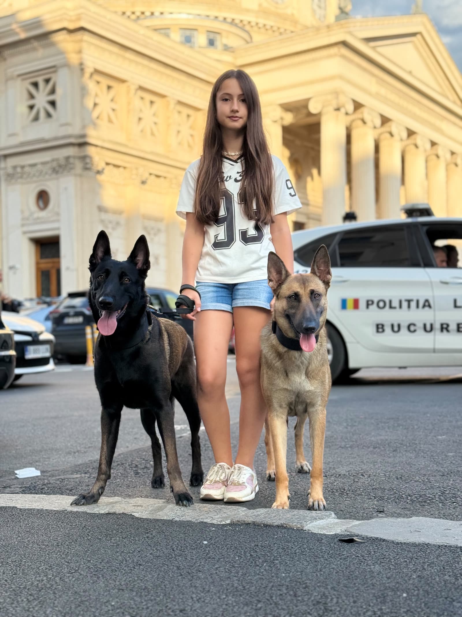 Tânără handler cu doi Malinois în fața Ateneului Român
